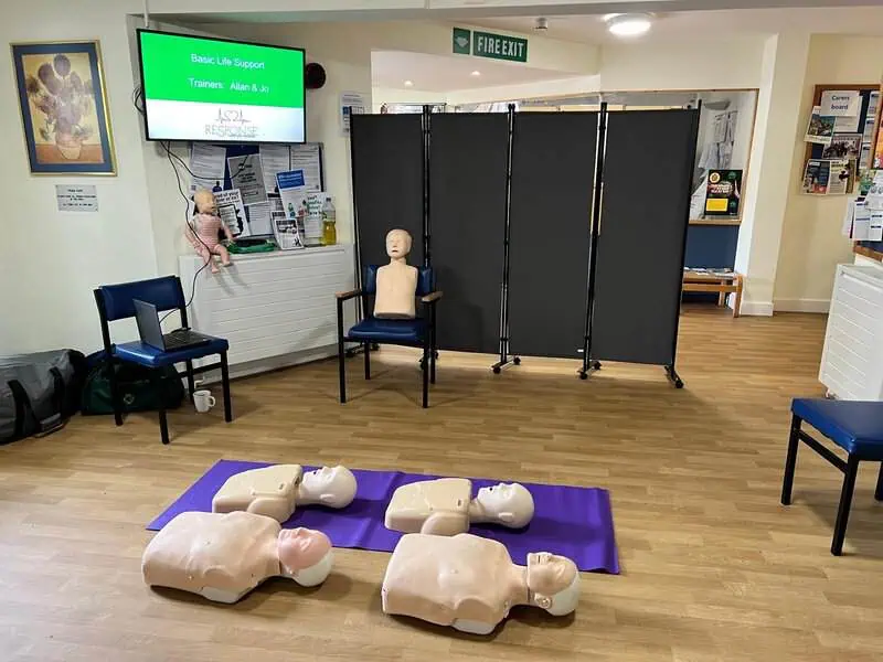 Instructor showing how to use AED